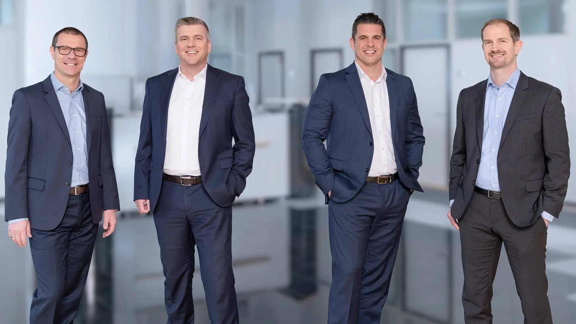 Gruppenaufnahme der audius Geschäftsführung – Die Vorstände der audius SE präsentieren sich als geschlossenes Management-Team in einem modernen Arbeitsumfeld.